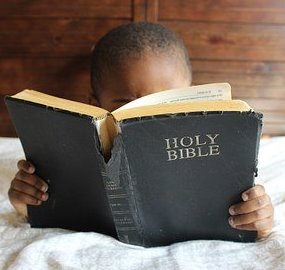 Child reading the bible